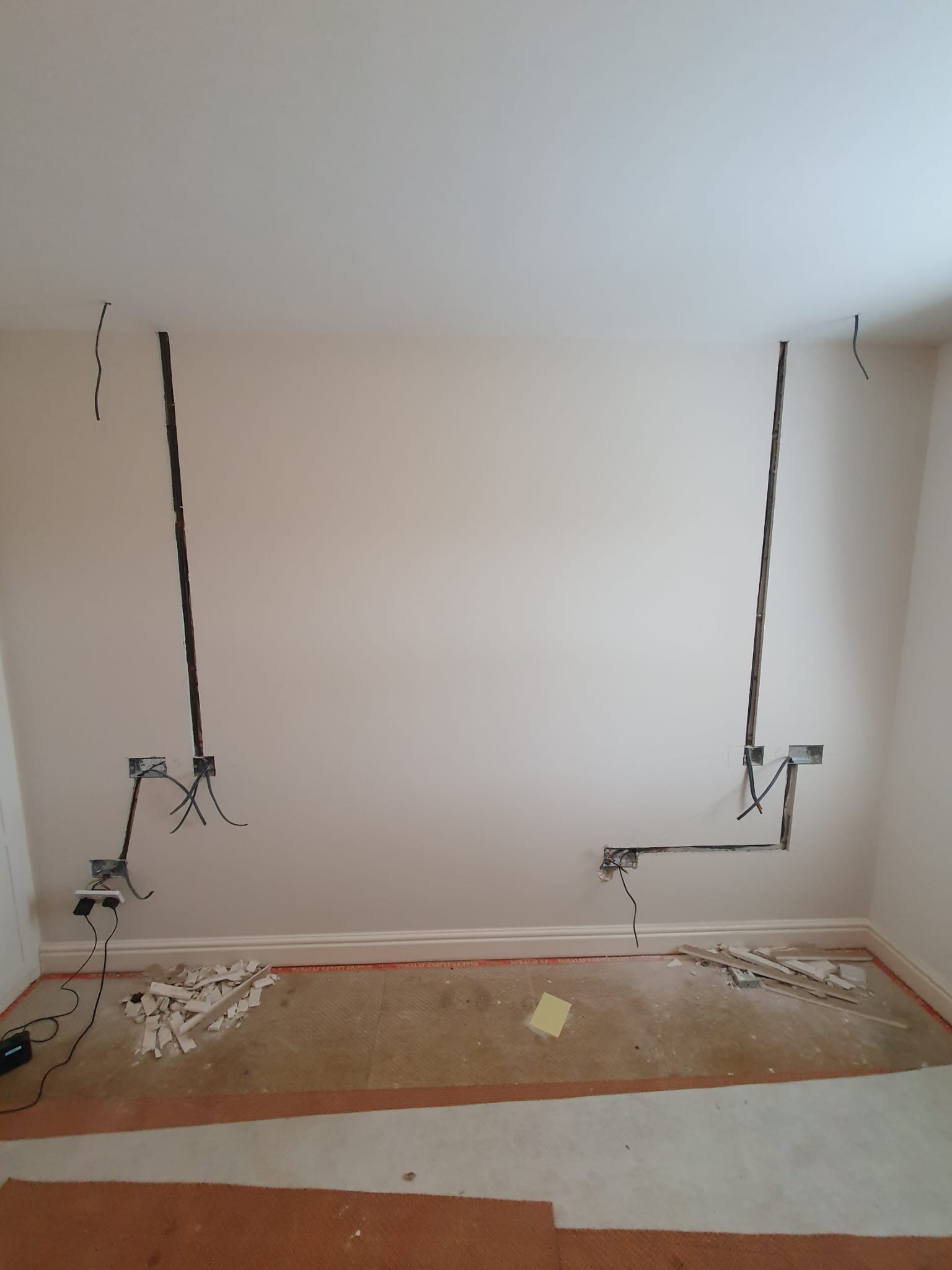 Cables chased into bedroom wall ready for new sockets