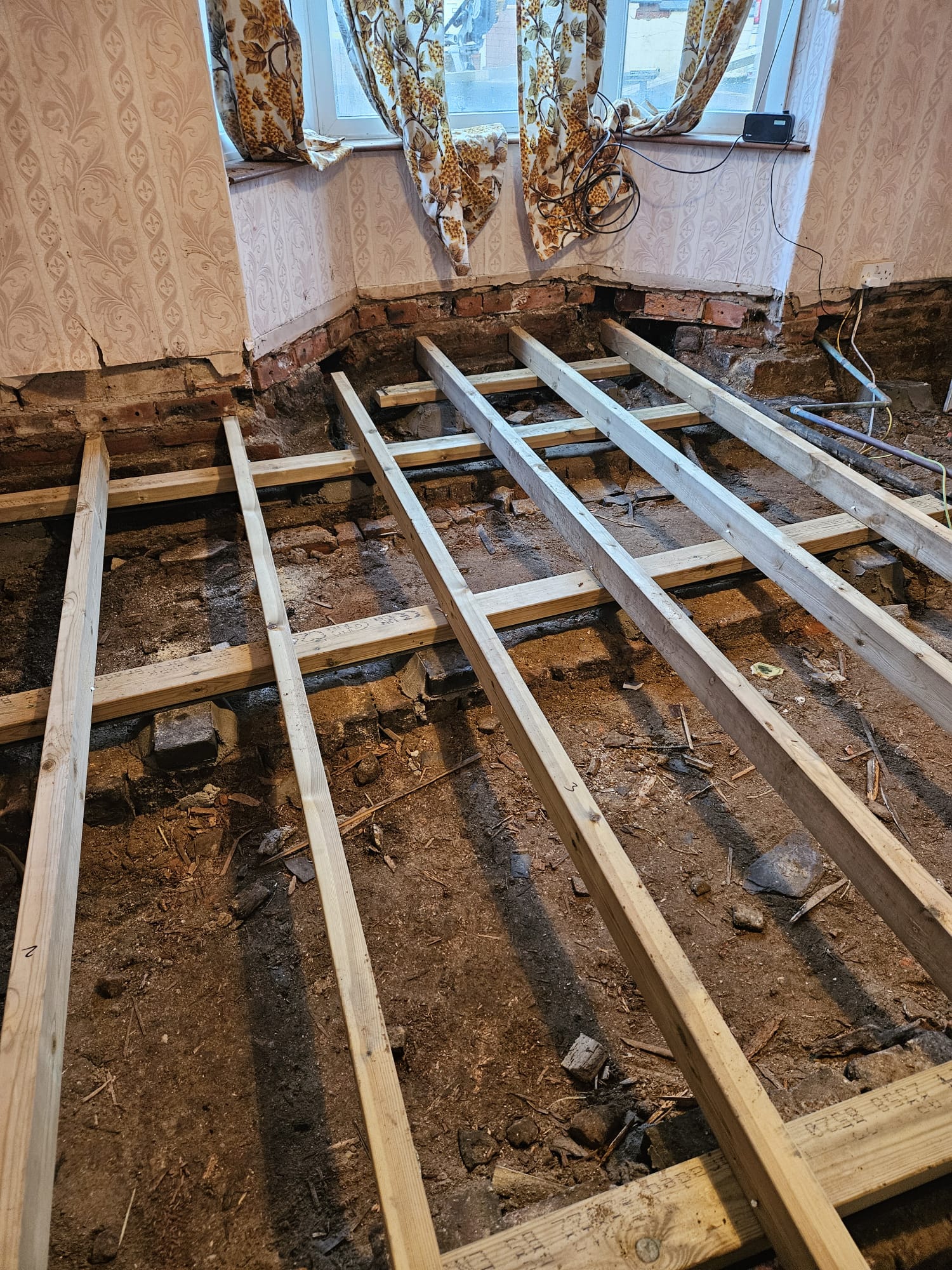 Fresh floor joists laid into a period property after rotten timbers removed