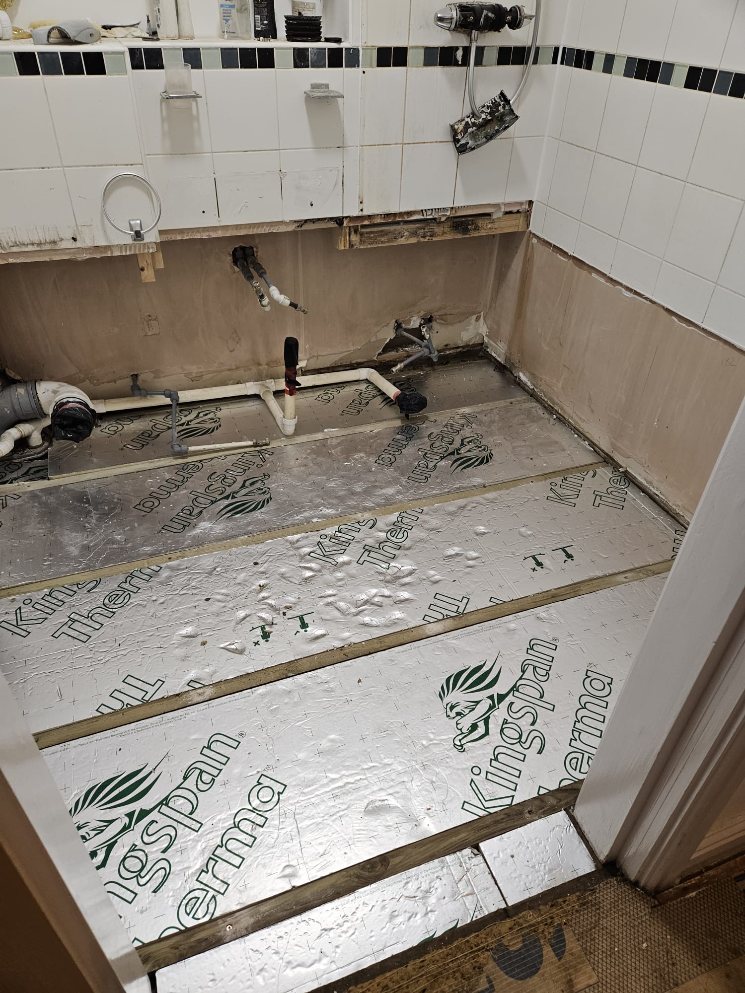 Kingspan rigid insulation laid between joists during a bathroom refurb