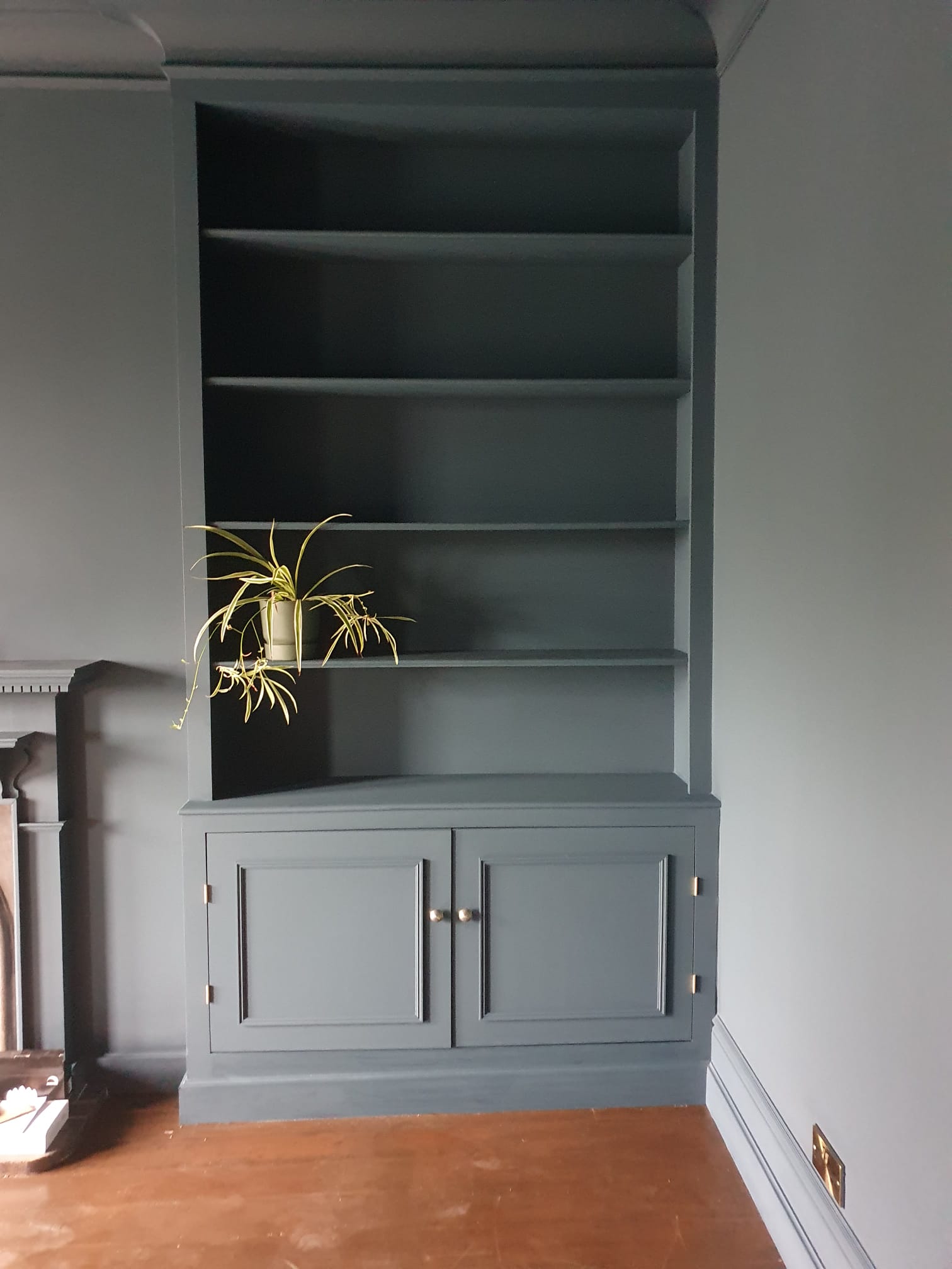 Bespoke alcove storage cabinet, painted dark blue-grey, in a period lounge